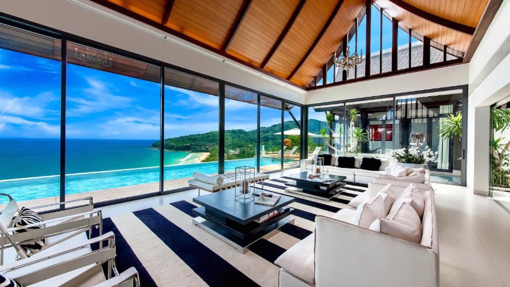 an open living room with a view of the ocean at Villa Paradiso in Nai Thon Beach