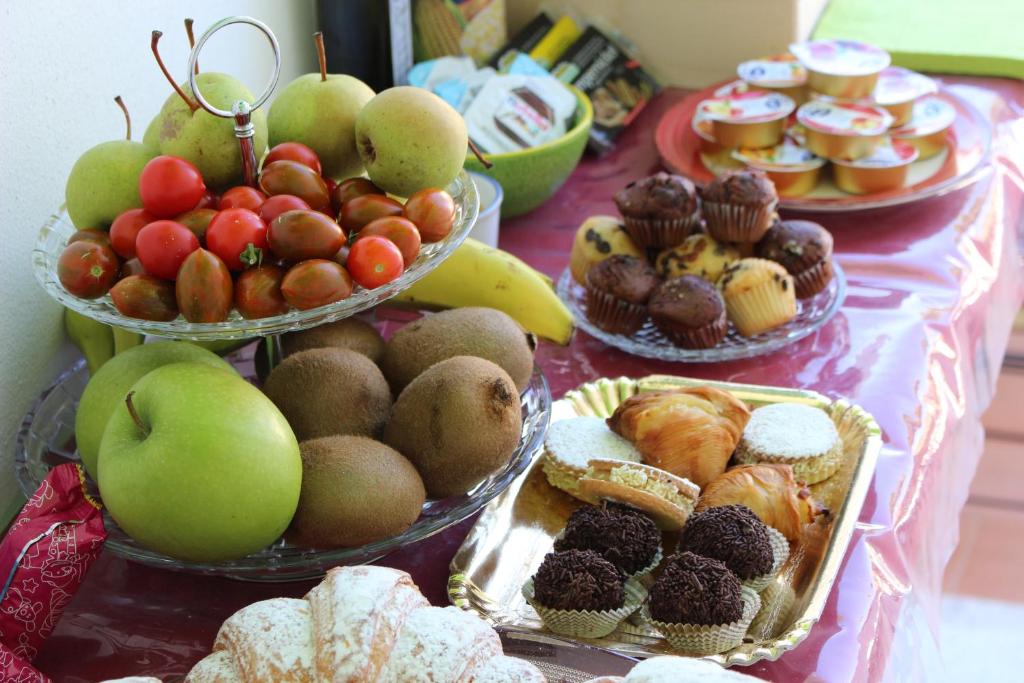 a table filled with different types of fruits and pastries at Villa Pollio Guest House in Anacapri
