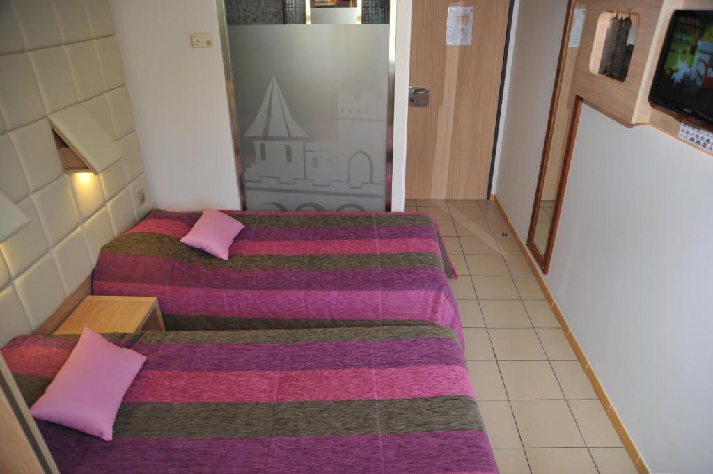 Postel nebo postele na pokoji v ubytování Hotel Espace Cite