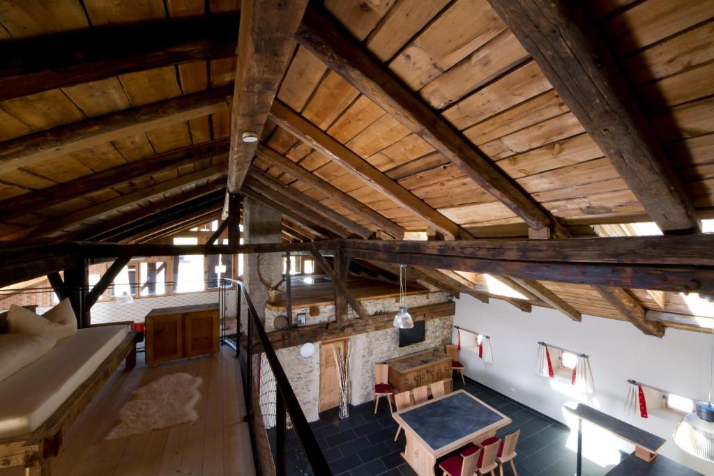 an attic view of a room with wooden ceilings at Hof Alpenjuwel in Nauders