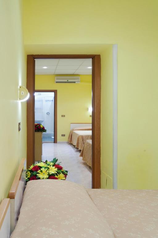 Postel nebo postele na pokoji v ubytování Hotel Oriente