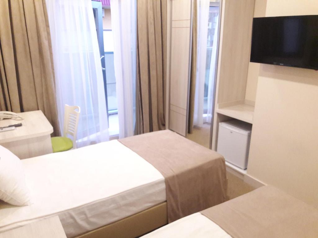 Postel nebo postele na pokoji v ubytování Hotel Green Glass