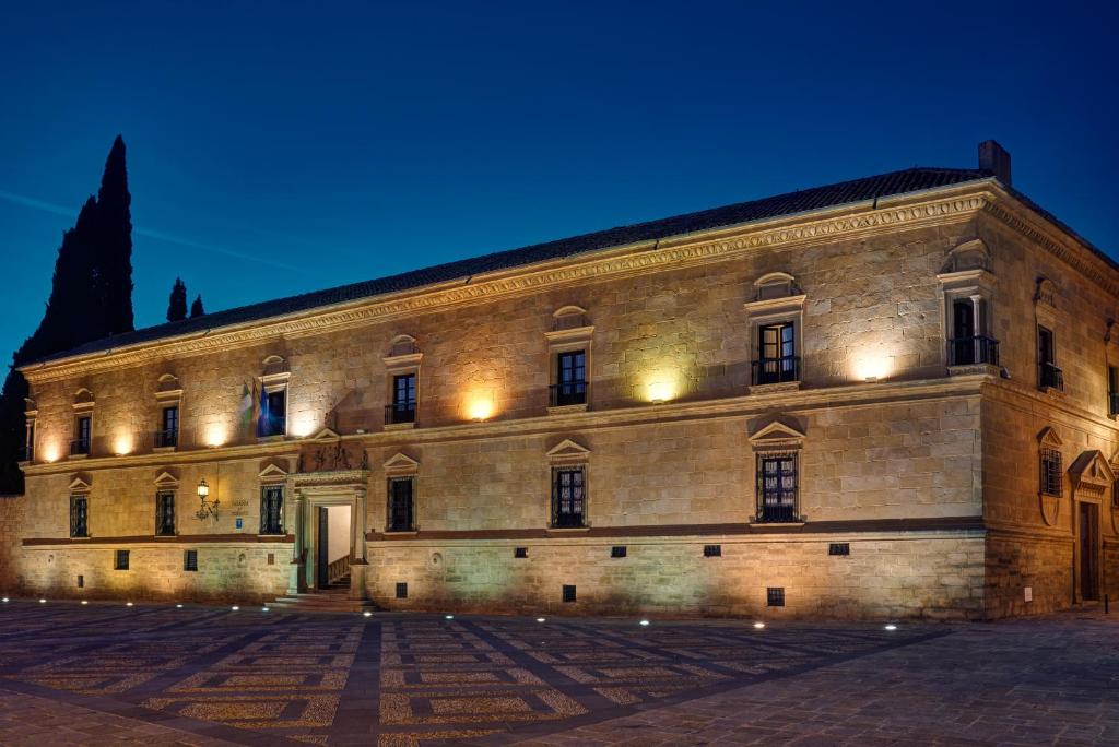 
a large building with a clock on the front of it at Parador de Ubeda in Úbeda
