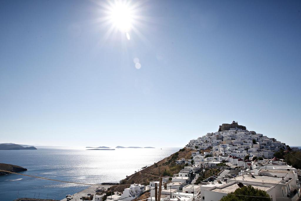 a view of a village on a hill next to the ocean at Galaxy studios in Astypalaia