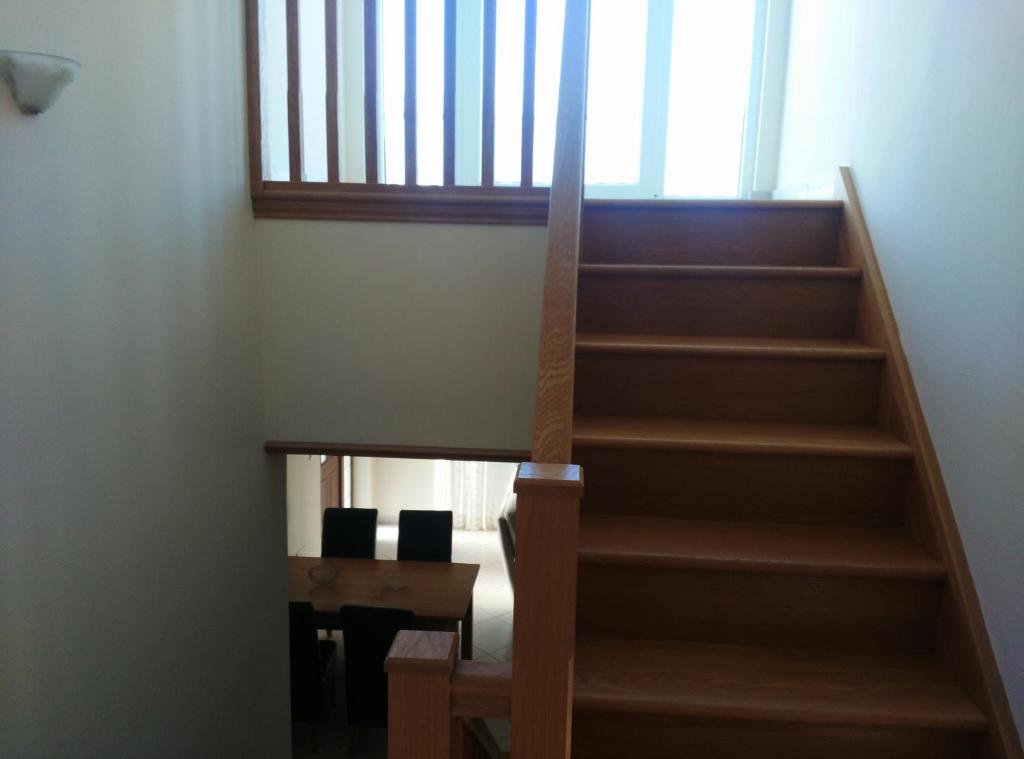 a staircase leading up to a room with a table at Pomos Harbourbiew Villa in Pomos