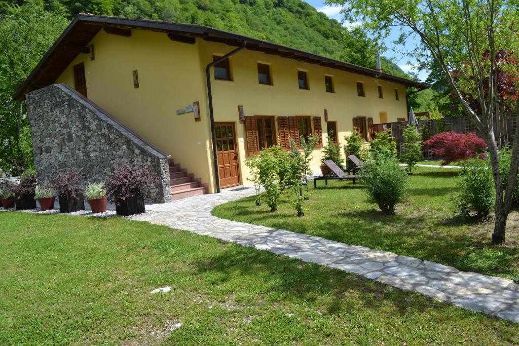 une maison avec un jardin en face dans l'établissement Počitniška hiša Lazar, à Kobarid