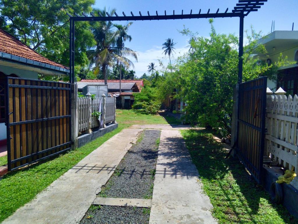 an entrance to a house with a fence at Randi Guest Mirissa in Mirissa
