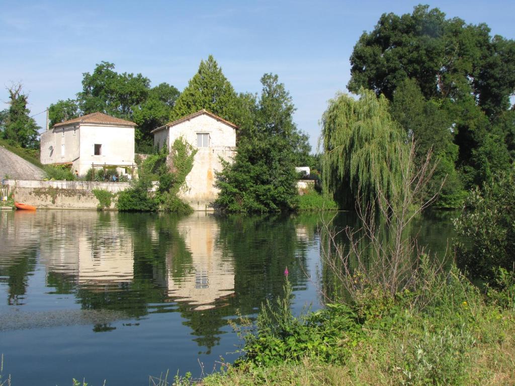 Blick auf einen Fluss mit Häusern und Bäumen in der Unterkunft Boutique B&B- The Riverside Retreat in Jarnac