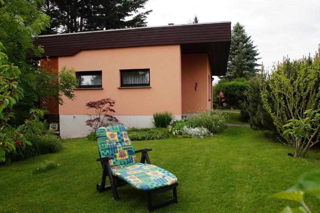a chair sitting in a yard in front of a house at Holiday Home Martina in Dresden
