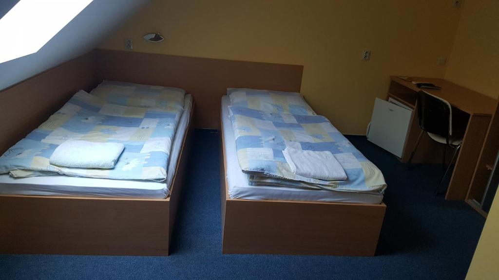 A bed or beds in a room at Lehár panzió