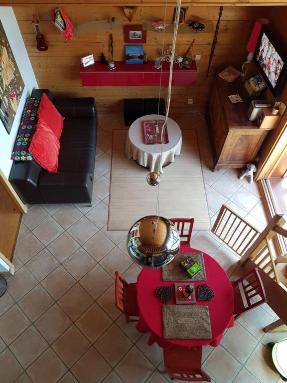 an overhead view of a living room with a red table at Arpege Des Neiges in Sainte-Foy-Tarentaise