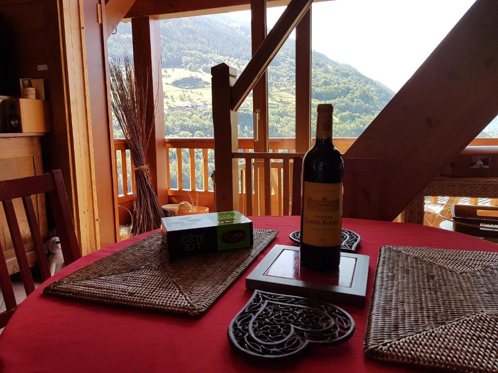a bottle of wine sitting on top of a table at Arpege Des Neiges in Sainte-Foy-Tarentaise