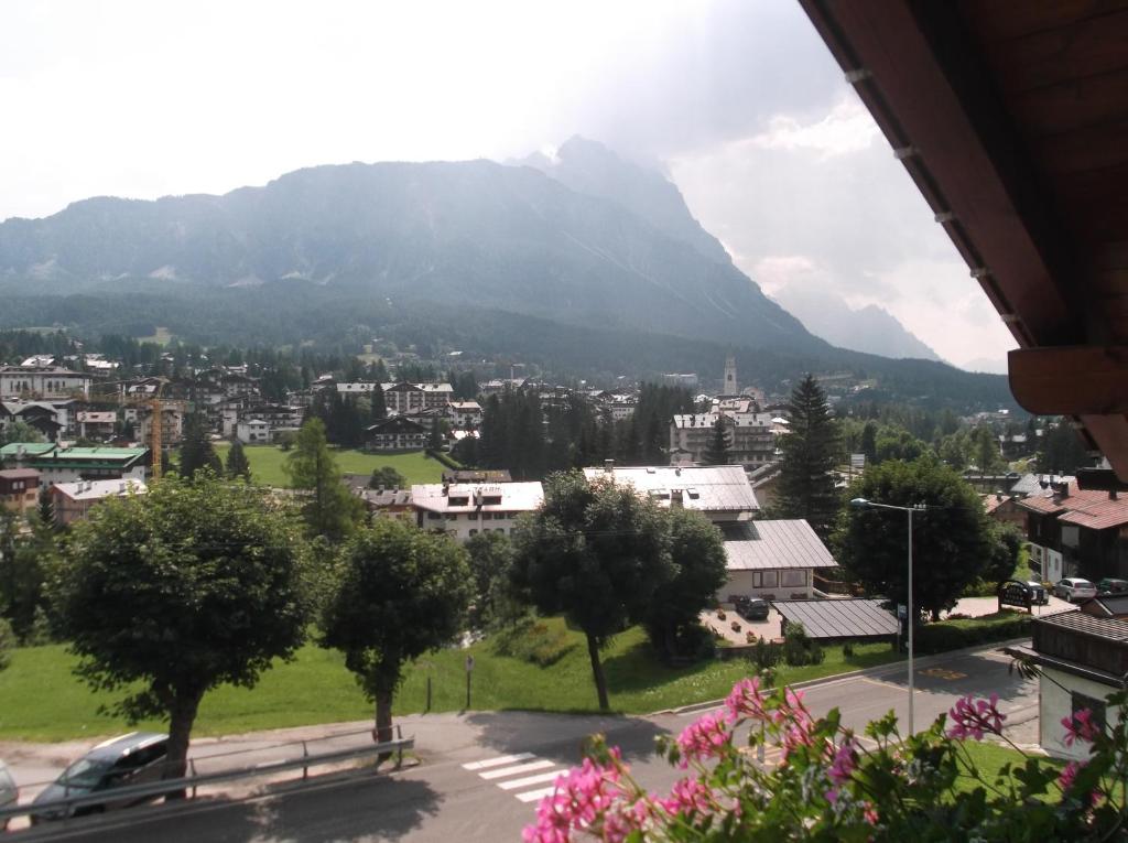 a view of a city with a mountain in the background at Hotel da Beppe Sello in Cortina dʼAmpezzo