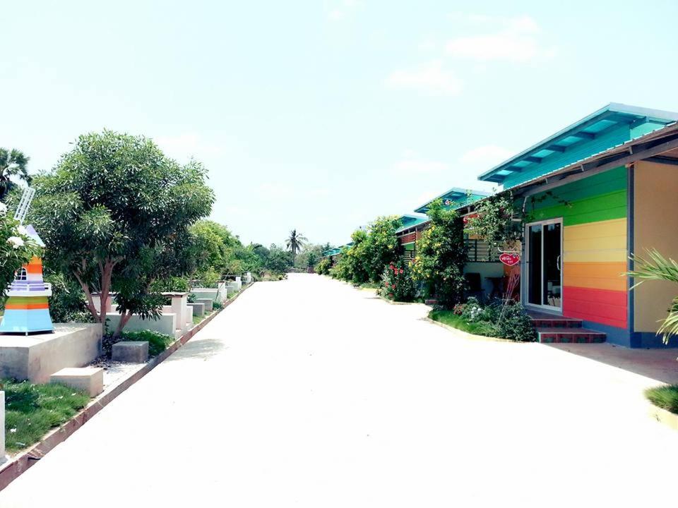 a street with a building with a rainbow at Pakjai resort in Chaiyaphum