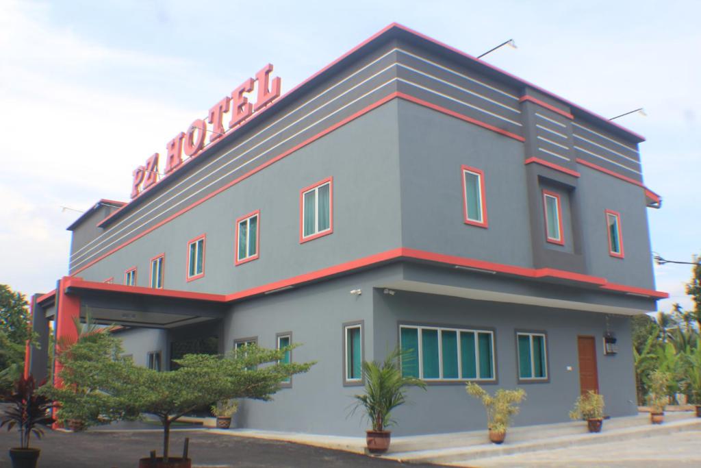 a building with a sign on top of it at Pz Hotel in Kuala Kangsar