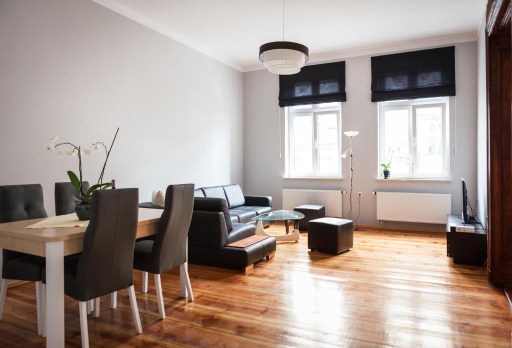 a living room with a table and a dining room at Czar Garbar in Poznań