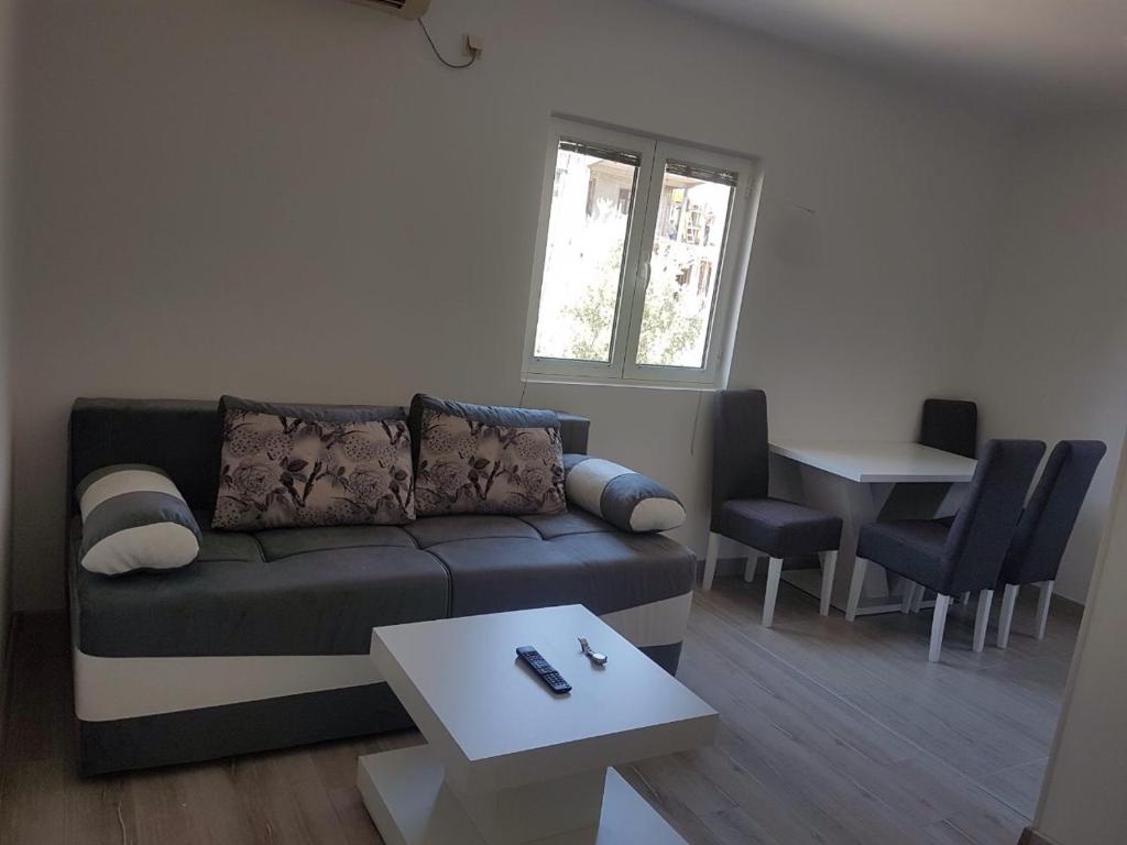 a living room with a couch and a table at Apartment Marijana in Tivat