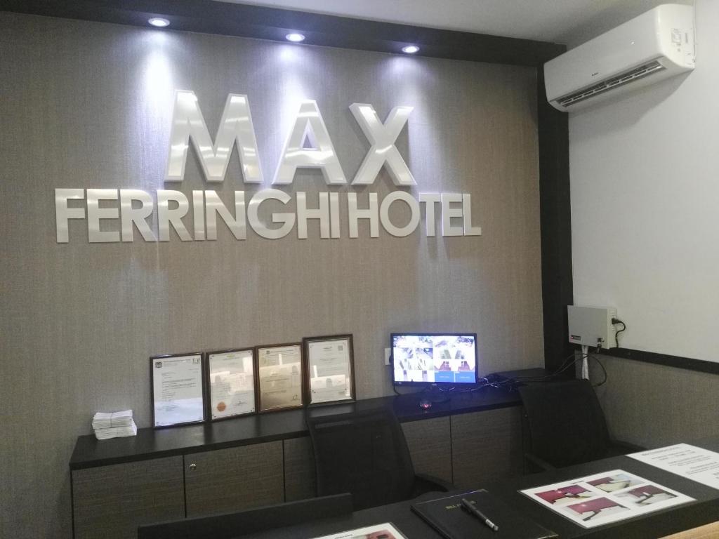 an office with a mayfair institution sign on a wall at Max Ferringhi Hotel in Batu Ferringhi