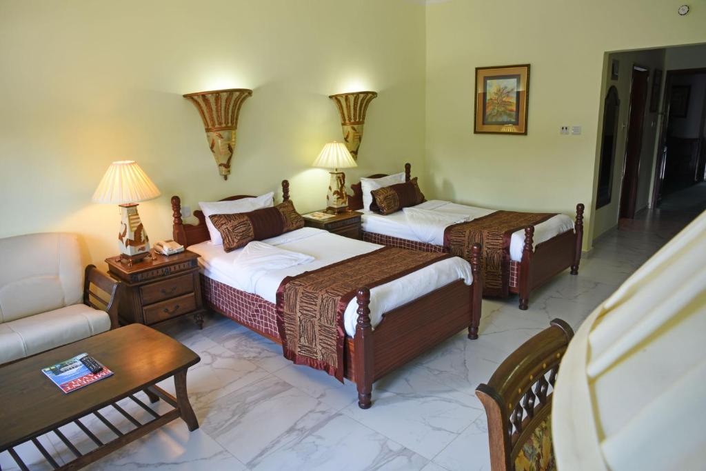 Imperial Resort Beach Hotel tesisinde bir odada yatak veya yataklar