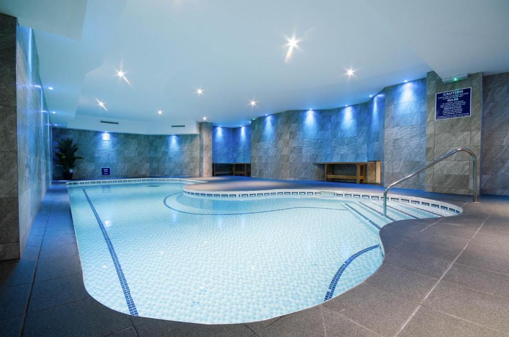 a large swimming pool in a large room at Durley Dean in Bournemouth