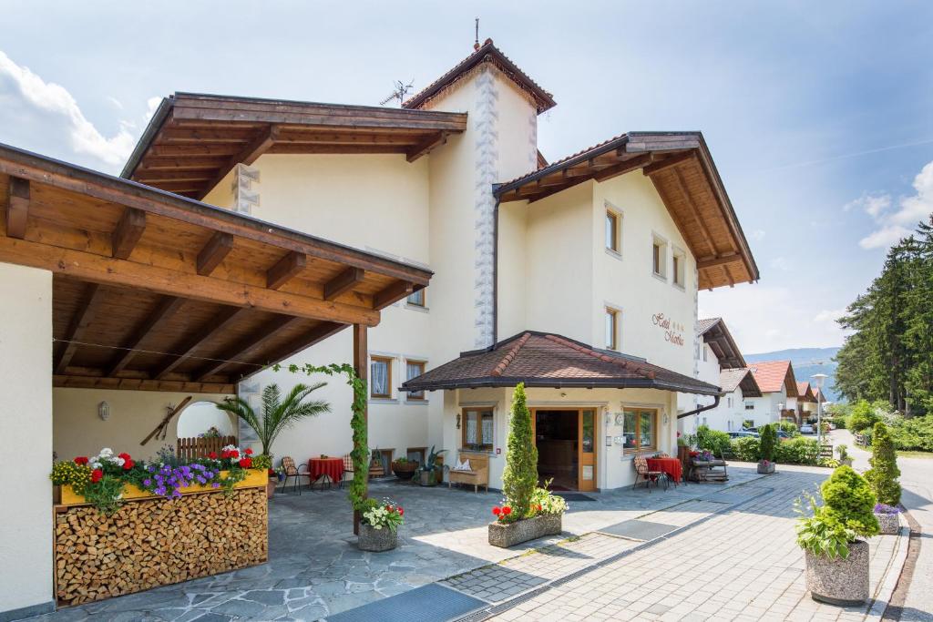 a villa with a courtyard in a resort at Hotel B&B Martha in Brunico