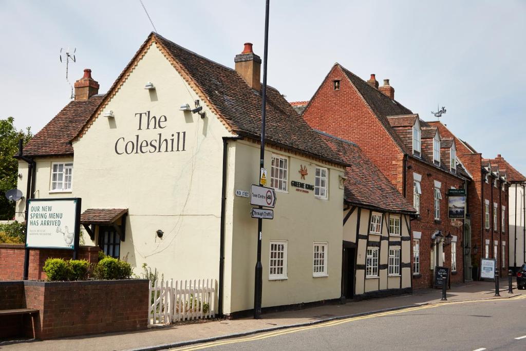 a white building on the side of a street at The Coleshill by Greene King Inns in Coleshill