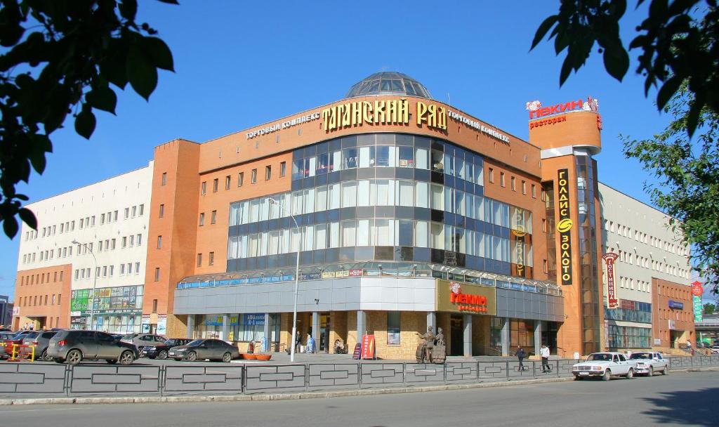 a large building with cars parked in front of it at Taganskaya Hotel in Yekaterinburg