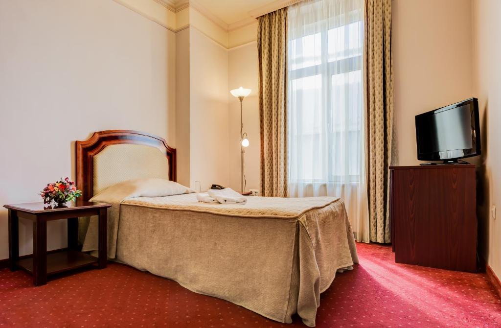 Postel nebo postele na pokoji v ubytování Boutique Splendid Hotel
