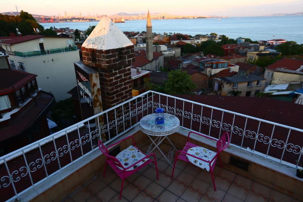 a table and chairs on a balcony with a view of the water at Emine Sultan Hotel in Istanbul