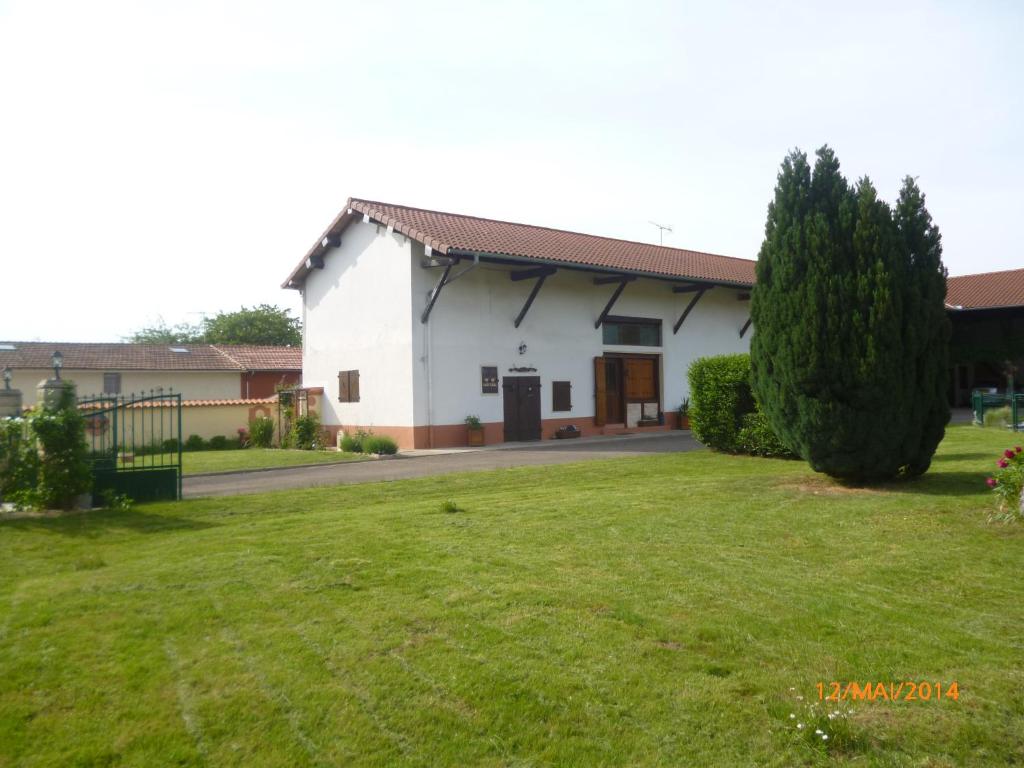 a white house with a green yard at La Sylreine in Crottet