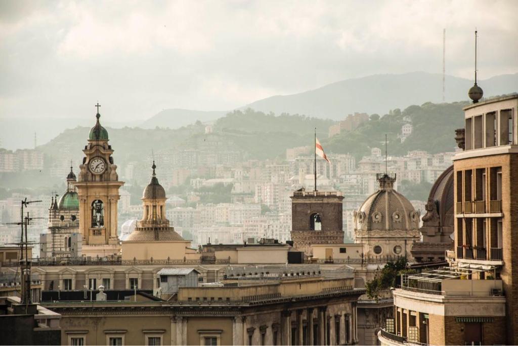a city skyline with buildings and a clock tower at Casa Matilde in Genova