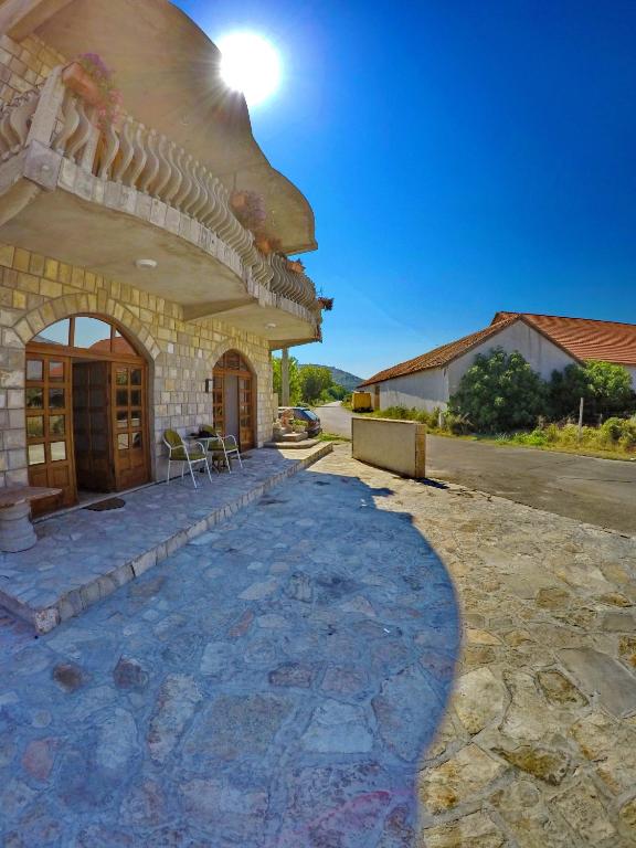 un edificio in pietra con un tetto su una strada di Apartmani Kosjerina a Trebinje
