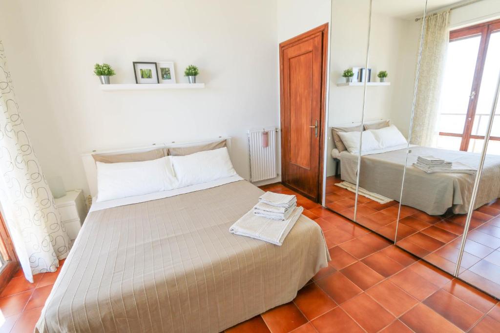a bedroom with a large bed and a mirror at Casa Bonita in Sanremo