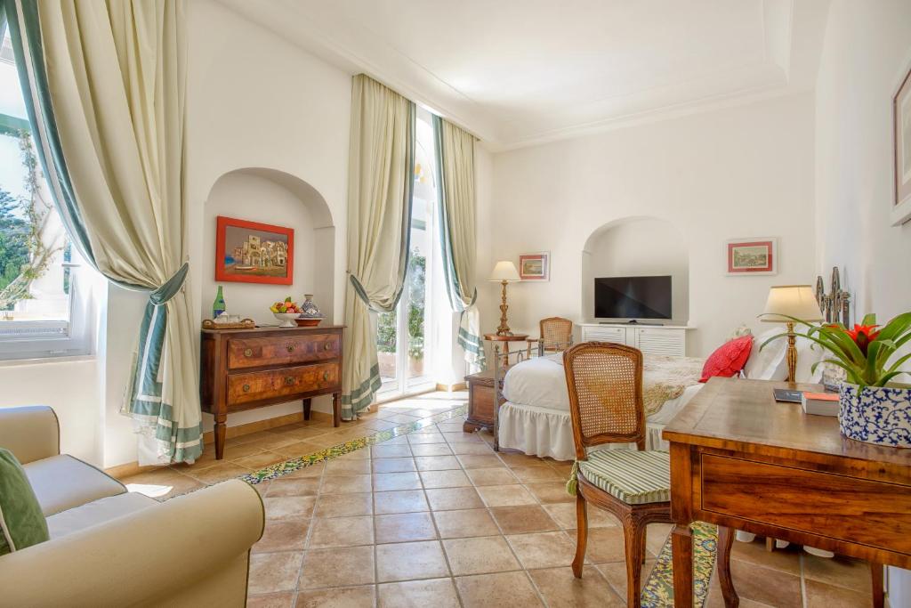 a living room with a couch and a table at Hotel Caesar Augustus in Anacapri