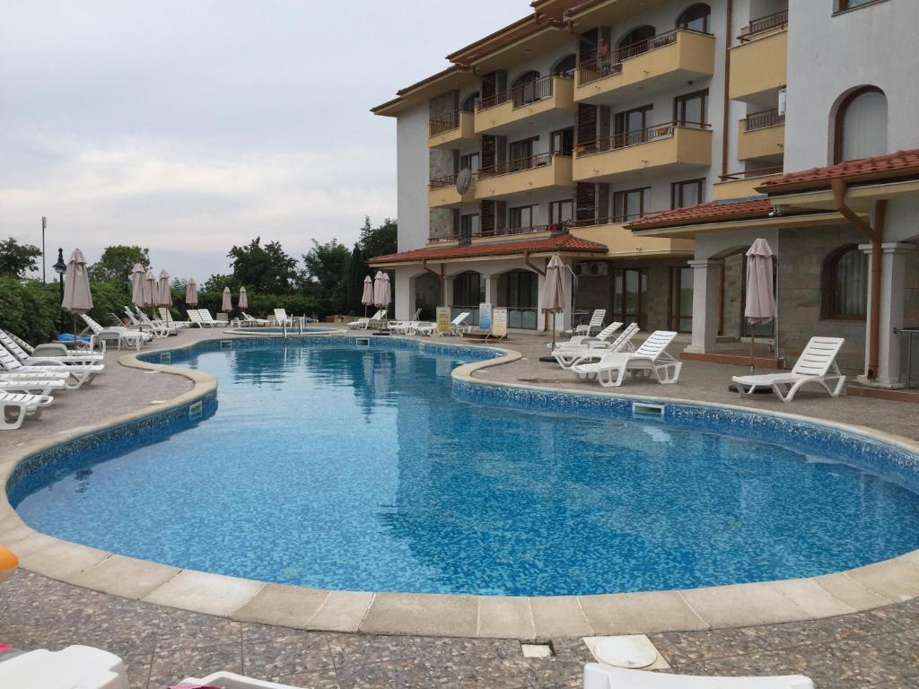 a large swimming pool in front of a building at Studio Apartment C32 in Dream Holiday Complex Ravda in Ravda