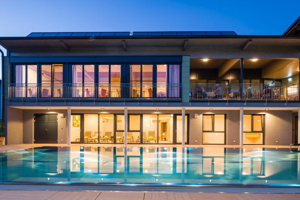 a house with a swimming pool at night at Gasthof Hotel Schmied in Arnfels