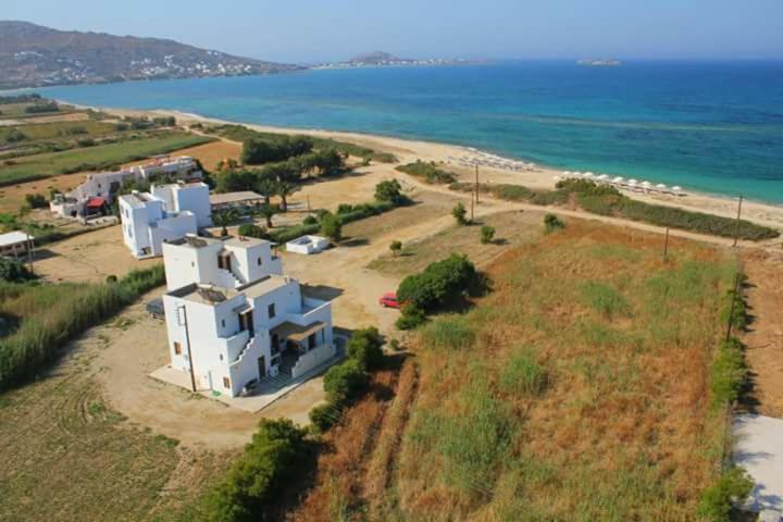 an aerial view of a white house on the beach at Nostos Plaka Beach in Plaka