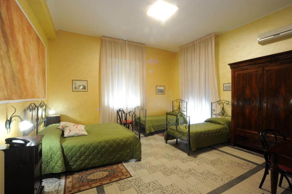 a bedroom with two beds and a dresser at Albergo Bellavista in Latina