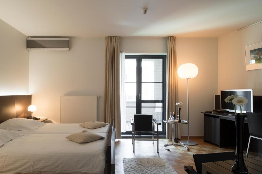 Postel nebo postele na pokoji v ubytování Hotel Verlooy