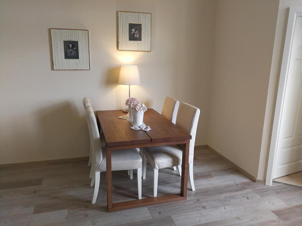 uma mesa de jantar com cadeiras e um candeeiro em Casa Herkules em Kassel