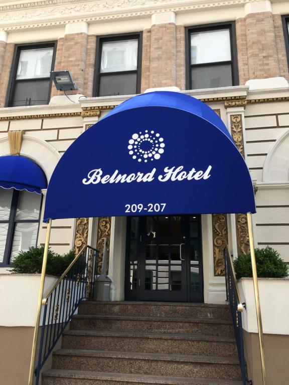 a blue and white building with a blue umbrella at Belnord Hotel in New York