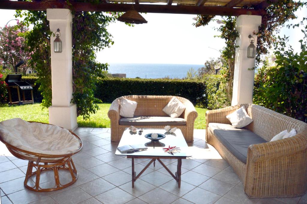 a patio with two couches and a coffee table at Villa 19 in Santa Cesarea Terme