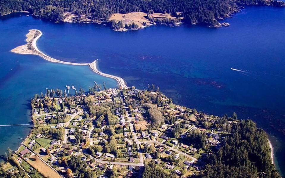 an aerial view of an island in the water at Salty Towers Ocean Front Cottages in Sooke