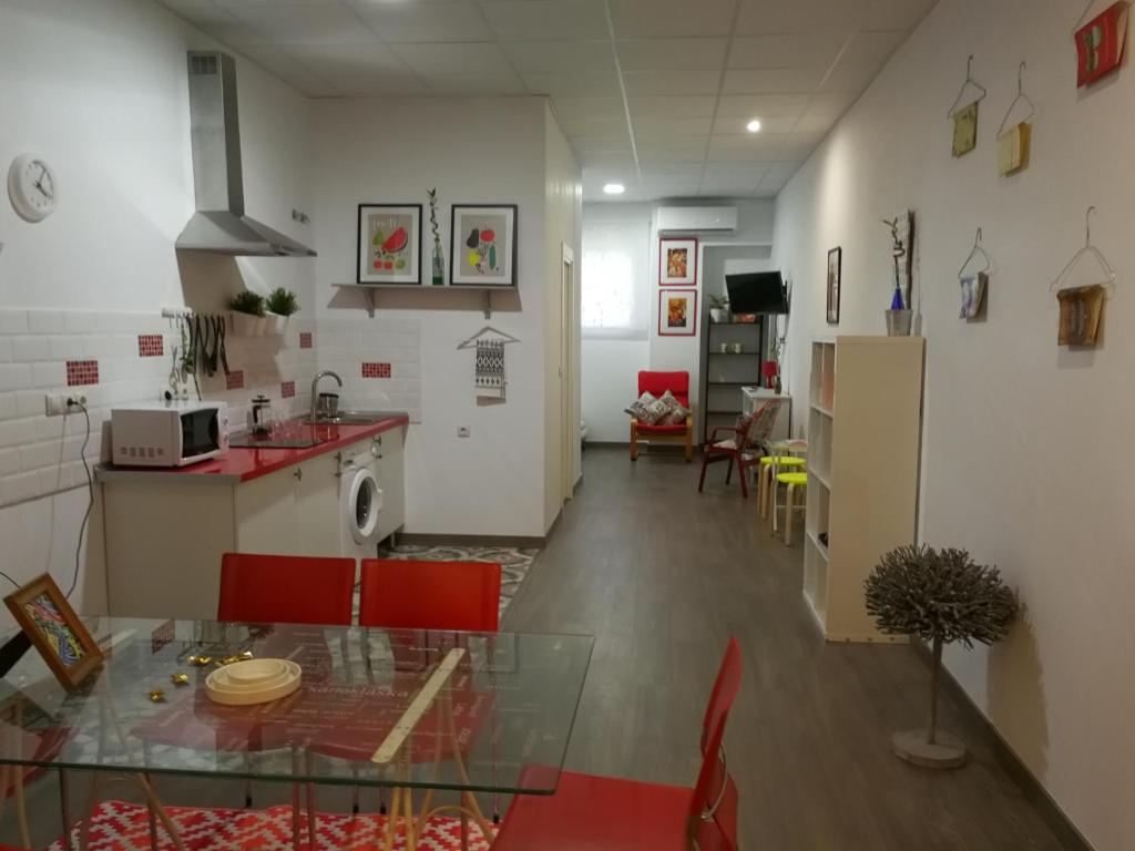 a kitchen and dining room with a glass table in a room at Huelintown in Málaga