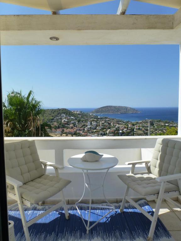 a room with two chairs and a table with a view at Seaview near Athens & Sounio in Anavissos