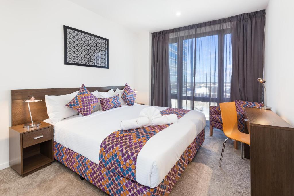 a hotel room with two beds and a television at City Edge Dandenong Apartment Hotel in Dandenong