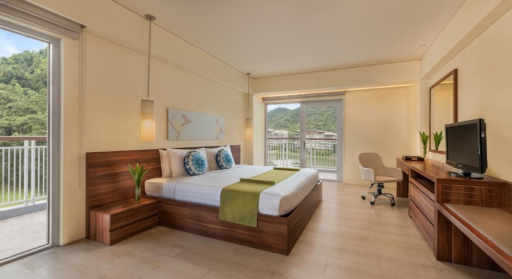 Postel nebo postele na pokoji v ubytování Pico Sands Hotel