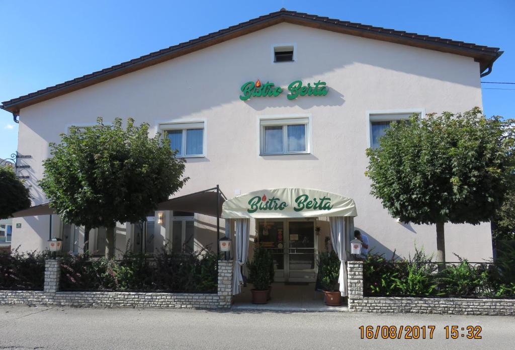 a white building with a white salt restaurant at Haus Berta in Braunau am Inn