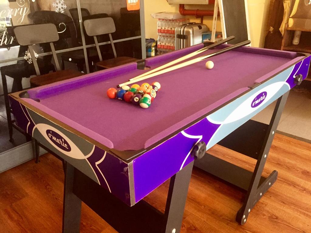 a purple pool table with balls on it at Tu Qu International Youth Hostel in Shanghai