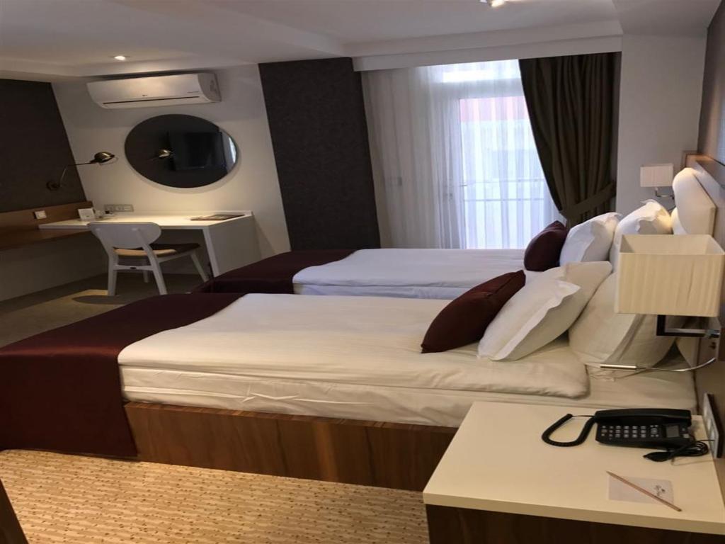 Postel nebo postele na pokoji v ubytování Endglory Hotel